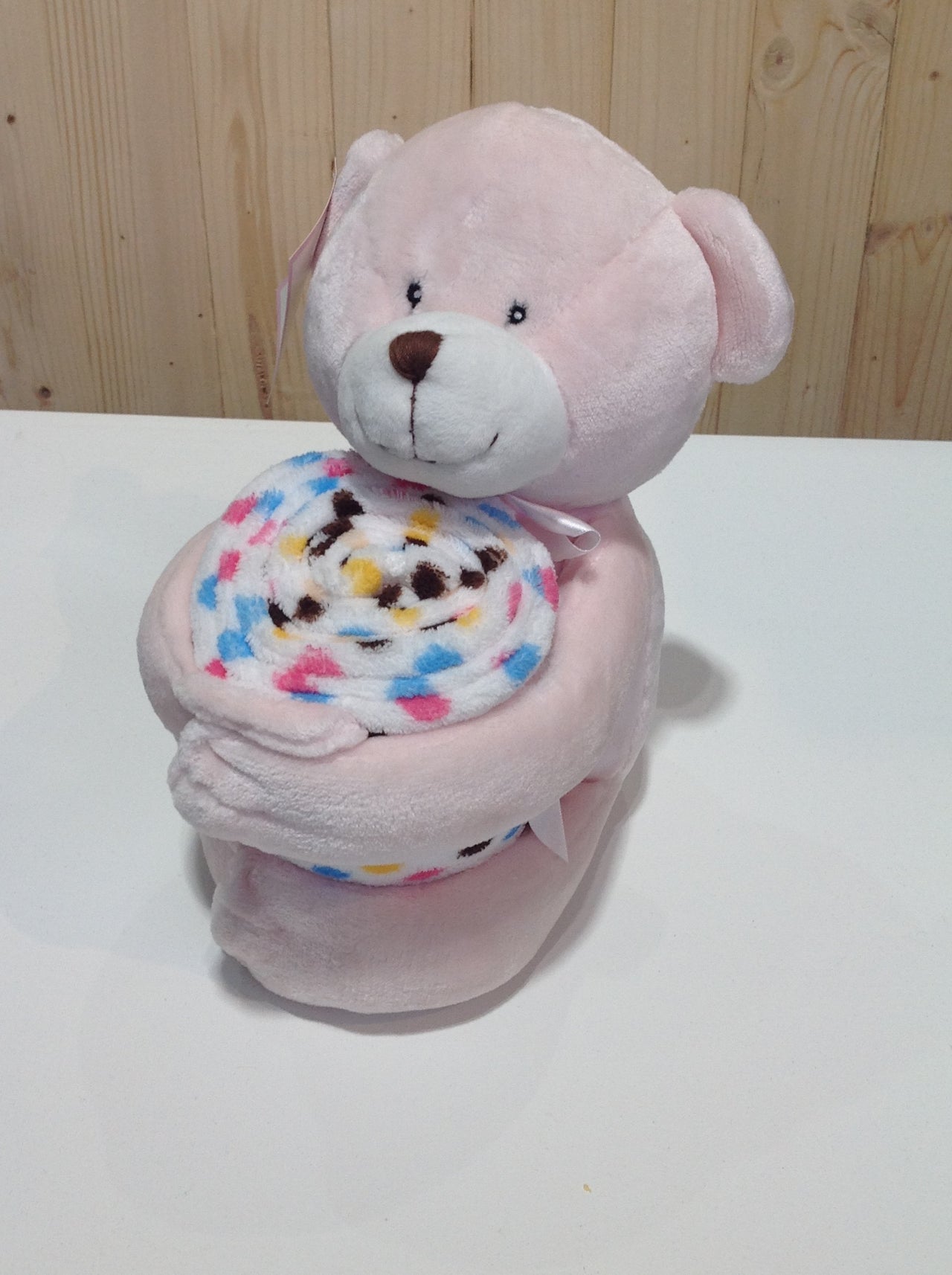 Pink teddy bear with blanket